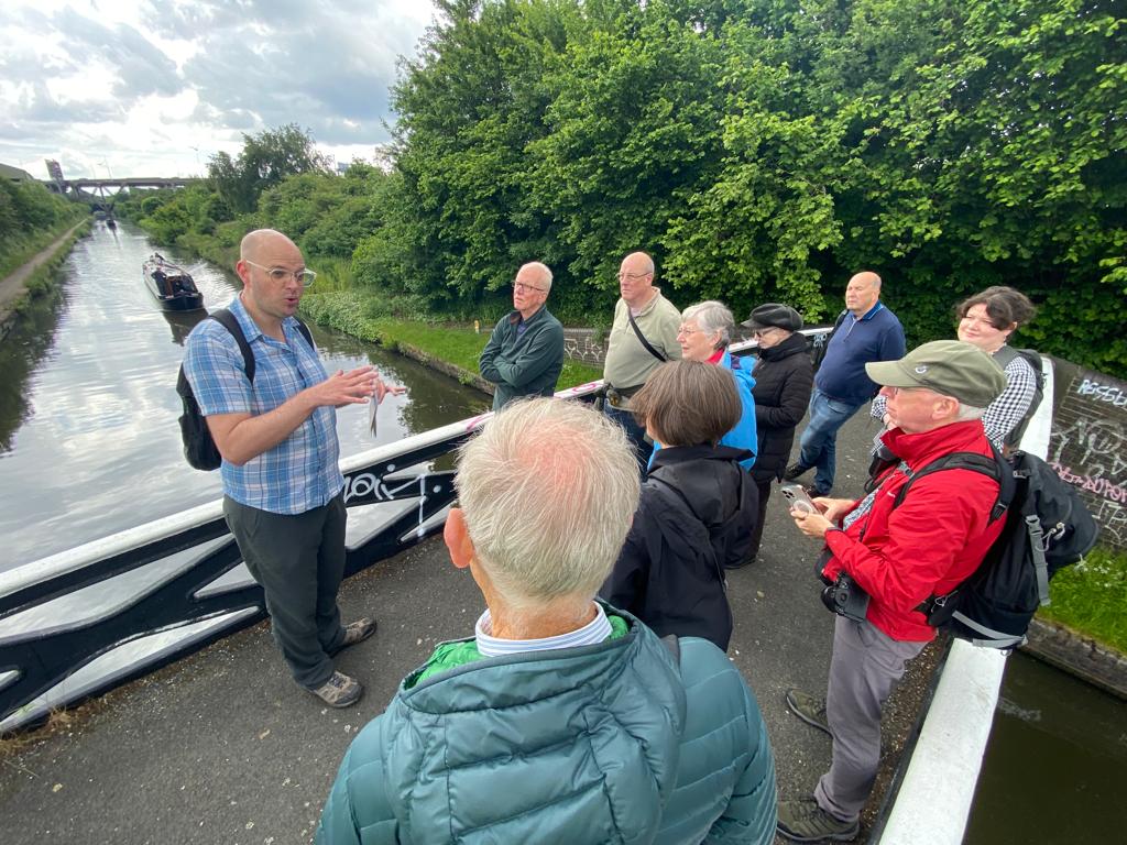Simon Briercliffe speaking to a group near a canal